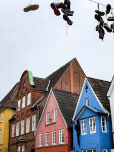 Flensburg, city, old town, Norderstraße, shoes, hanging shoes, architecture, northern Germany, row of houses, Schleswig-Holstein, Germany