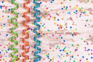 Confetti and streamers on background with copy square Confetti and streamers on background with copy square