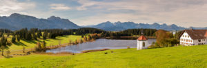 Panorama landscape in the Allgäu near Füssen with mountain range of the Alps at the Hegratsried pond Panorama landscape in the Allgäu near Füssen with mountain range of the Alps at the Hegratsried pond