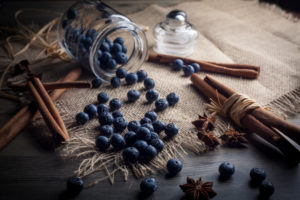 Blueberries and cinnamon sticks on jute cloth Blueberries and cinnamon sticks on jute cloth