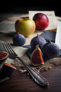 Figs and apples with old silver cutlery Figs and apples with old silver cutlery