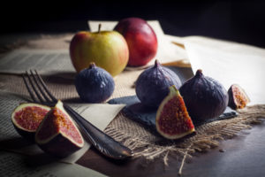 Figs and apples with old silver cutlery Figs and apples with old silver cutlery