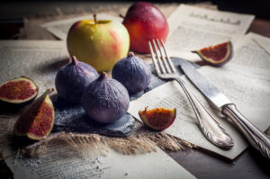 Figs and apples with old silver cutlery Figs and apples with old silver cutlery