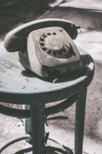 Dusty old telephone on stool Dusty old telephone on stool