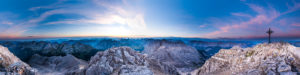 Morgenrot with a small red sun in the distance and the summit cross of the Birkkarspitze in the Karwendel. Morgenrot with a small red sun in the distance and the summit cross of the Birkkarspitze in the Karwendel.