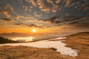 Spring sunrise at Simetsberg in the Ester Mountains, in the background the Walchensee and the Karwendel in the German and Austrian Alps Spring sunrise at Simetsberg in the Ester Mountains, in the background the Walchensee and the Karwendel in the German and Austrian Alps