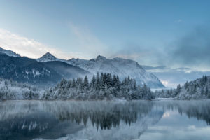 Sunrise at the winter reservoir Krün after nightly fresh snow and in the background the Karwendel mountains Sunrise at the winter reservoir Krün after nightly fresh snow and in the background the Karwendel mountains