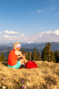 Trail runner Katharina Kirschner enjoys the view of the Walchensee and the mountains of the German Alps during a sport break Trail runner Katharina Kirschner enjoys the view of the Walchensee and the mountains of the German Alps during a sport break