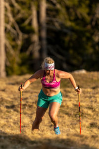 Concentrated trail runner with a natural figure while mountain running on Simetsberg on spring meadow Concentrated trail runner with a natural figure while mountain running on Simetsberg on spring meadow