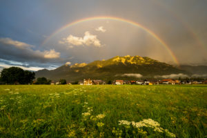 rainbow over the Bavarian town of Krün in the Alps. In the background the Schöttelspitze and Soierngruppe in the Karwendel foothills, illuminated by the evening sun. rainbow over the Bavarian town of Krün in the Alps. In the background the Schöttelspitze and Soierngruppe in the Karwendel foothills, illuminated by the evening sun.