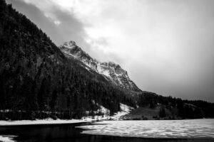 Broken up ice at Ferchensee in the Bavarian Alps above Mittenwald in early spring. In the background the Wetterstein mountains with dense clouds and fresh snow.