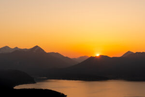 Sunset with orange evening sky over the Walchensee, in the background the Simetsberg, the Estergebirge.