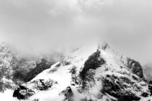 Bad weather with snow and dense clouds with fog at the Alpspitze above Garmisch-Partenkirchen. Seen from Krün.