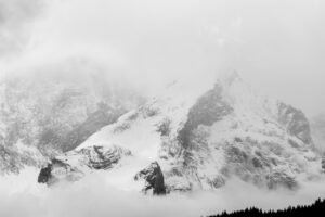 Bad weather with snow and dense clouds with fog at the Alpspitze above Garmisch-Partenkirchen. Seen from Krün.
