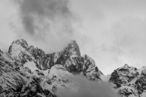 The Hochblassen in the Wetterstein mountains in bad weather in spring with snow and dense clouds or fog. The striking mountain stands out with its rock walls.