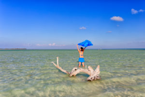 Female Tourist sunbathing on an idyllic beach in Holbox Female Tourist sunbathing on an idyllic beach in Holbox