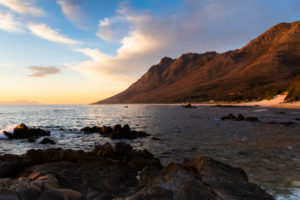 Sunset at False Bay (South Africa) with clouds and boulders on the foreground, Western Cape, South Africa Sunset at False Bay (South Africa) with clouds and boulders on the foreground, Western Cape, South Africa