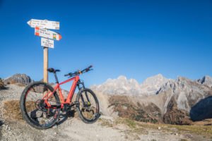 An ebike MTB at La Palacia fork in the San Nicolò valley with Marmolada on the background, Trentino, Dolomitenes, Italy