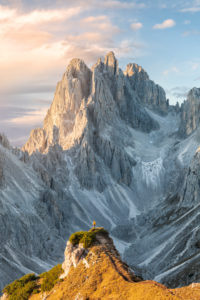 Hiker standing in front of the sharp peaks of Cadini di Misurina, Dolomites, Auronzo di Cadore, Belluno, Veneto, Italy