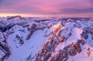 aerial view of dolomites mountains at sunrise with sasso vernale, cima uomo, marmolada group, on the horizon the pale di san martino and the lagorai mountain range, italy