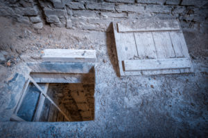trapdoor in the floor with staircase in an abandoned factory, veneto, italy,