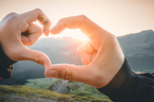 mother and daughter, woman and girl join hands creating the shape of the heart with the setting sun mother and daughter, woman and girl join hands creating the shape of the heart with the setting sun