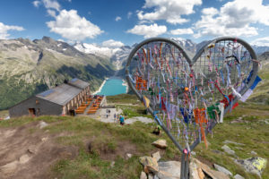 heart-shaped iron installation near the refuge Olperer with Lake Schlegeispeicher on the background, Zillertal Alps, Tyrol, Schwaz district, Austria heart-shaped iron installation near the refuge Olperer with Lake Schlegeispeicher on the background, Zillertal Alps, Tyrol, Schwaz district, Austria