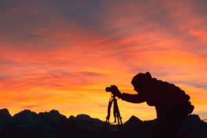 Silhouette of photographer taking pictures in mountain at sunset, Dolomites Silhouette of photographer taking pictures in mountain at sunset, Dolomites