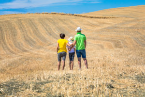 family, father, mother and young daughter from behind look at the hills in Val d'Orcia, Castiglione d'Orcia, province of Siena, Tuscany, Italy family, father, mother and young daughter from behind look at the hills in Val d'Orcia, Castiglione d'Orcia, province of Siena, Tuscany, Italy