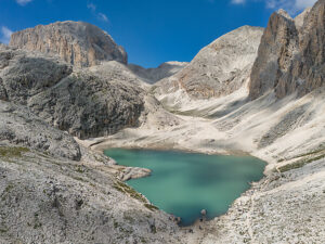 Aerial view of Lake Antermoia on a sunny summer day, nestled in the Dolomites' Catinaccio group, Val di Fassa, Trentino, Italy