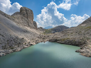 Aerial view of Lake Antermoia on a sunny summer day, nestled in the Dolomites' Catinaccio group, Val di Fassa, Trentino, Italy