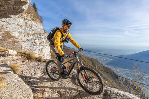 E-mountain biker riding solo along the historic Granatiere Trail on Monte Cengio, Vicenza Province, Veneto, Italy