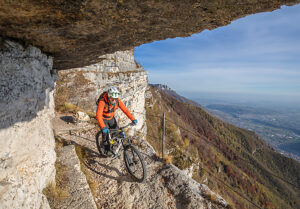 E-mountain biker riding solo along the historic Granatiere Trail on Monte Cengio, Vicenza Province, Veneto, Italy
