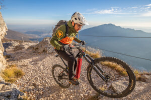 E-mountain biker riding solo along the historic Granatiere Trail on Monte Cengio, Vicenza Province, Veneto, Italy