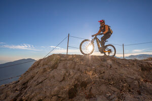 E-mountain biker riding solo along the historic Granatiere Trail on Monte Cengio, Vicenza Province, Veneto, Italy