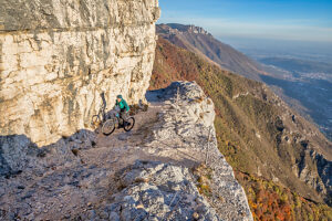 E-mountain biker riding solo along the historic Granatiere Trail on Monte Cengio, Vicenza Province, Veneto, Italy