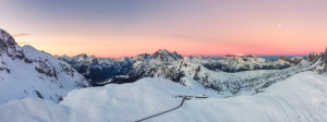 Aerial view of Passo Giau on a freezing winter dawn, with the Sella Group, the Marmolada, and the distant Pale di San Martino on the horizon. Dolomites, Colle Santa Lucia municipality, Belluno province, Veneto region, Italy
