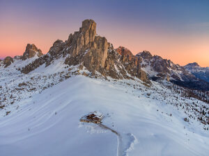 Aerial winter view of Passo Giau in winter at twilight, Colle Santa Lucia, Belluno, Dolomites, Italy