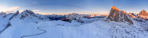 Wide-angle aerial view of Passo Giau in winter, with numerous iconic Dolomite peaks forming a spectacular mountain backdrop. Dolomites, Colle Santa Lucia municipality, Belluno province, Veneto region, Italy