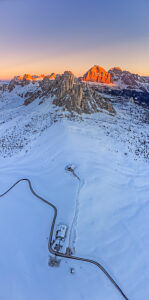 Aerial winter view of Passo Giau in winter at twilight, Colle Santa Lucia, Belluno, Dolomites, Italy