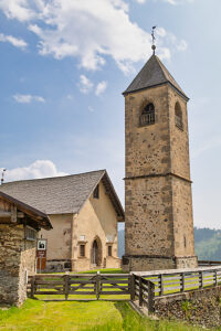 The Church of San Leonardo Vecchio, a unique Gothic-medieval architectural gem built in the mid-1500s by Nicolo Roupel, stands peacefully in Casamazzagno, Comelico Superiore, Belluno Province, Veneto, Italy
