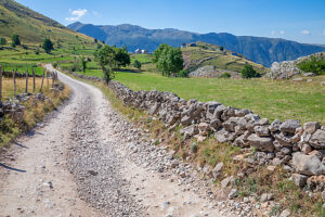 The dirt road lined with dry stone walls leading to the remote village of Lukomir, surrounded by the landscape of the Bjelasnica mountains, Lukomir, Konjic, Herzegovina-Neretva Canton, Bosnia and Herzegovina The dirt road lined with dry stone walls leading to the remote village of Lukomir, surrounded by the landscape of the Bjelasnica mountains, Lukomir, Konjic, Herzegovina-Neretva Canton, Bosnia and Herzegovina