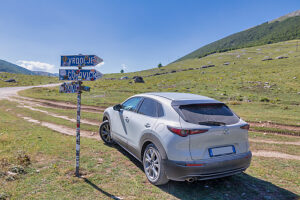 A crossover vehicle on the Bjelasnica plateau at the fork leading to Lukomir, with weathered and worn road signs, Municipality of Konjic, Herzegovina-Neretva Canton, Bosnia and Herzegovina A crossover vehicle on the Bjelasnica plateau at the fork leading to Lukomir, with weathered and worn road signs, Municipality of Konjic, Herzegovina-Neretva Canton, Bosnia and Herzegovina