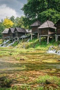 Historic watermills at Mlincici, surrounded by lush greenery and flowing waters, Jajce, Central Bosnia Canton, Bosnia and Herzegovina Historic watermills at Mlincici, surrounded by lush greenery and flowing waters, Jajce, Central Bosnia Canton, Bosnia and Herzegovina