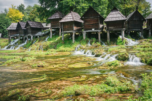Historic watermills at Mlincici, surrounded by lush greenery and flowing waters, Jajce, Central Bosnia Canton, Bosnia and Herzegovina Historic watermills at Mlincici, surrounded by lush greenery and flowing waters, Jajce, Central Bosnia Canton, Bosnia and Herzegovina