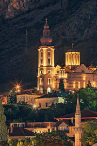 Night view of Mostar with illuminated Orthodox Cathedral, church towers, and mosque minaret, Mostar, Herzegovina-Neretva Canton, Bosnia and Herzegovina Night view of Mostar with illuminated Orthodox Cathedral, church towers, and mosque minaret, Mostar, Herzegovina-Neretva Canton, Bosnia and Herzegovina