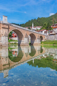 Historic Ottoman stone bridge Stara Cuprija (Old Bridge) reflected in the clear waters of the Neretva River, Konjic, Herzegovina-Neretva Canton, Bosnia and Herzegovina Historic Ottoman stone bridge Stara Cuprija (Old Bridge) reflected in the clear waters of the Neretva River, Konjic, Herzegovina-Neretva Canton, Bosnia and Herzegovina