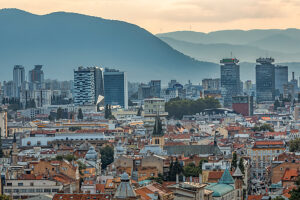 Panoramic view of Sarajevo with mix of historic rooftops, churches, mosques and modern skyscrapers, surrounded by mountains, Bosnia and Herzegovina Panoramic view of Sarajevo with mix of historic rooftops, churches, mosques and modern skyscrapers, surrounded by mountains, Bosnia and Herzegovina