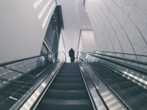 person on the end of a escalator on oculus station in nyc