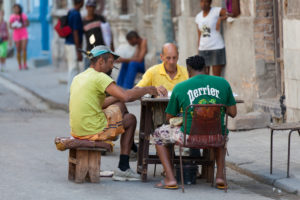 Caribbean, Cuba, Havana, three men playing at dominoes, roadside Caribbean, Cuba, Havana, three men playing at dominoes, roadside